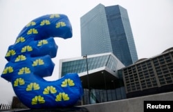 An inflated euro sign is seen outside the new head quarters of the European Central Bank (ECB) in Frankfurt, Jan. 22, 2015.