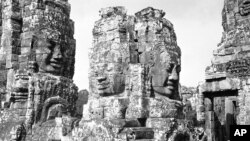 Brooding stone faces look down on the Bayon Temple in the ruins of Angkor, the ancient capital of the Khmer Empire in Cambodia on July 5, 1960. The identical faces, all bearing the same smile, are said to be symbols of Jayavarman VII, the last great build