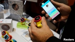 FILE - The hereO GPS watch for children and its accompanying mapping app are displayed at the International Consumer Electronics show (CES) in Las Vegas, Nevada, Jan. 4, 2015.