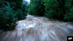 Boulder Creek roils at high speed after days of record rain and flooding, at the base of Boulder Canyon, Sept. 13, 2013, in Boulder, Colorado. 