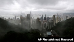 Clouds hang low over the city of Hong Kong, seen from the Victoria Peak, in Hong Kong, Aug. 13, 2013.