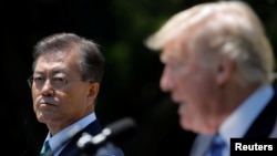 South Korean President Moon Jae-in and U.S. President Donald Trump, right, deliver a joint statement from the Rose Garden of the White House in Washington, June 30, 2017.