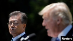 South Korean President Moon Jae-in and U.S. President Donald Trump, right, deliver a joint statement from the Rose Garden of the White House in Washington, June 30, 2017.