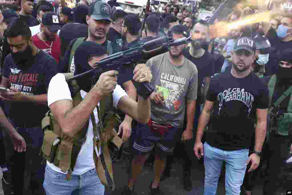 Supporters of the Shiite Amal group fire weapons in the air during the funeral processions of Hassan Jamil Nehmeh, who was killed during clashes the day before, in the southern Beirut suburb of Dahiyeh, Lebanon.
