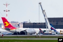 A crane works at the site of the damaged Sukhoi SSJ100 aircraft of Aeroflot Airlines in Sheremetyevo airport, outside Moscow, Russia, May 6, 2019.