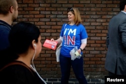 FILE - A woman campaigns in London for Britain to stay in the European Union, May 20, 2016.