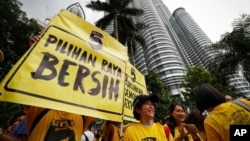 Activists from the Coalition for Clean and Fair Elections (BERSIH) show a placard reading "Clean Election BERSIH" during a rally in Kuala Lumpur, Malaysia, Nov. 19, 2016.