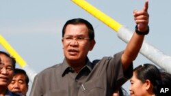 FILE - Cambodian Prime Minister Hun Sen, shown delivering a speech in Phnom Penh in January, calls Sam Rainsy, head of the opposition Cambodia National Rescue Party, a “traitor’s son.”
