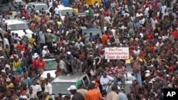 Protesters gather as thousands rally to call for the departure of South African company Waymark, which was hired by the Guinean government to re-do the country's electoral list, in Conakry, Guinea, September 20, 2012.