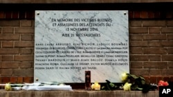 A memorial plaque is seen next to La Belle Equipe restaurant, in Paris, Nov. 13, 2016. A year ago the Islamic State group brought its extremist war to Paris, seeding terror with attacks on a rock concert, the national stadium and bustling sidewalk cafes.