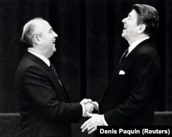 SWITZERLAND -- U.S. President Ronald Reagan (R) shakes hands at his first meeting with Soviet leader Mikhail Gorbachev to sign an arms treaty in Geneva, November 19, 1985