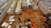 FILE - Workers lay during a break as they prepare election materials before their distribution to polling stations in a warehouse in Jakarta, Indonesia, April 15, 2019. 