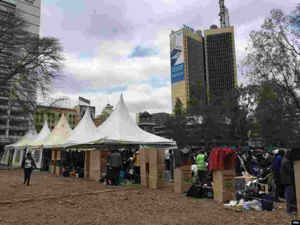 Cardboard voting booths are seen at a parking lot that has been temporarily converted into polling center, in downtown Nairobi, Kenya, Aug. 8, 2017. (J. Craig/VOA)