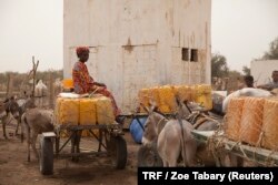 A woman sits on a donkey cart in Hadad, Gorgol region, Mauritania, March 30, 2018.