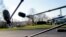 FILE - Members of the media with microphones wait for President Donald Trump to speak on the South Lawn of the White House in Washington, March 13, 2018.