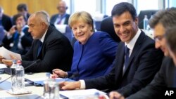 La canciller alemana Angela Merkel (centro), asiste a una mesa redonda durante una cumbre informal de la Unión Europea sobre migración en la sede de la EU, en Bruselas, el domingo 24 de junio de 2018. (Olivier Hoslet, Pool Photo via AP).