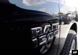 FILE - A Dodge Ram 1500 is on display on the lot at Planet Dodge in Miami, Oct. 1, 2014.