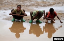 Children wash their heads with rain water in the village of Kobo, one of the drought stricken areas of Oromia region in Ethiopia, April 28, 2016.