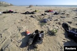 Clothes belonging to migrants lie on the beach of Siculiana, in Western Sicily, Italy, Feb. 19, 2016.