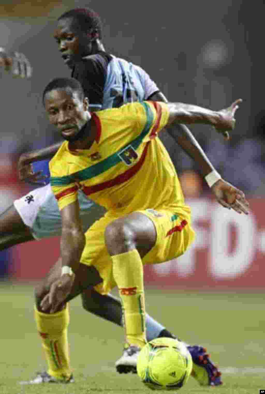 Mali's Seydou Keita (12) plays against Botswana's Mogakolodi Ngele during their final African Cup of Nations Group D soccer match at the Stade De L'Amitie Stadium in Libreville February 1, 2012.