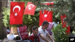 People rest in Kugulu Park in Ankara, Turkey, June 24, 2013. 