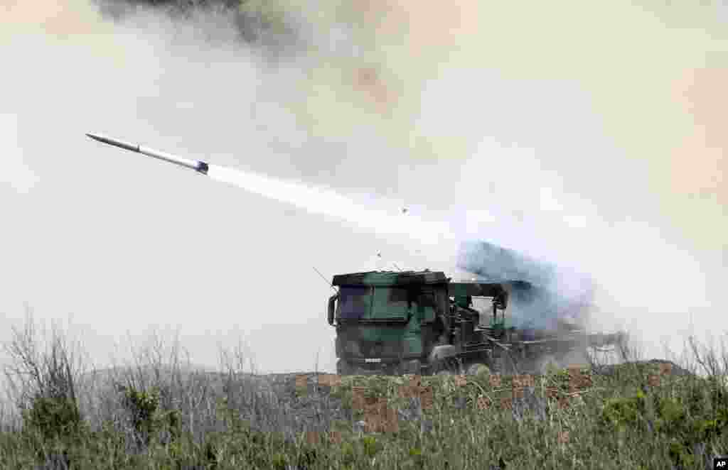 A Thunderbolt-2000 wheeled MLRS system fires at a target during the annual Han Kuang exercises on the outlying Penghu Island, Taiwan.
