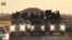 FILE - An image grab taken from a video released by Islamic State group's official Al-Raqqa site via YouTube allegedly shows Islamic State (IS) group recruits riding in armed trucks in an unknown location. 