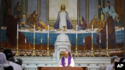 FILE - Archbishop of Delhi state Anil Couto reads from a holy book during a service on Good Friday at the Sacred Heart Cathedral in New Delhi, India.