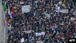 Students and other citizens attend a demonstration as they block the main boulevard in the central Serbian city of Kragujevac on Feb. 15, 2025, continuing monthslong calls for government accountability and reforms.