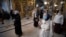 Parishioners wearing face masks to protect against coronavirus observe social distancing guidelines as they cross themselves at the Epiphany Cathedral in Moscow, Russia, June 2, 2020. 