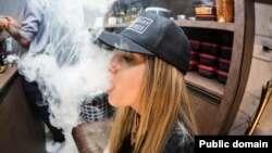 young woman vaping e-cigarette