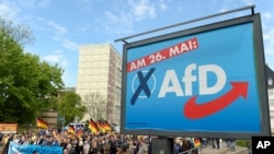 FILE - AfD supporters walk in Erfurt, Germany, May 1, 2019.