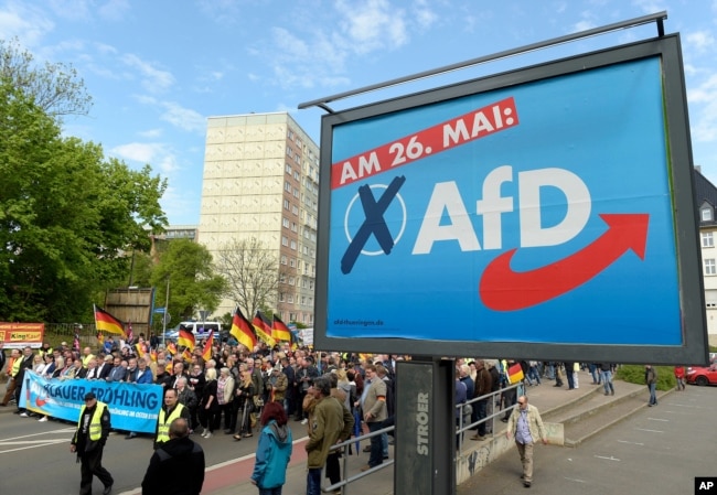 FILE - AfD supporters walk in Erfurt, Germany, May 1, 2019.