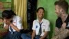 FILE - UNICEF Goodwill Ambassador David Beckham smiles with Sripun, 15, left, and her friend Ego, center, in Semarang, Indonesia, March 27, 2018. Beckham met with students as part of a UNICEF anti-bullying program. 