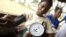FILE - A nurse trainee measures a pregnant woman's blood pressure during a prenatal consultation at the United Brethren in Christ Hospital in the town of Mattru Jong, Bonthe District, Sierra Leone.