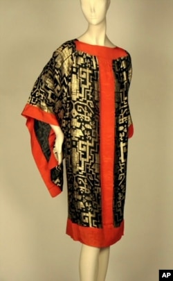 This image provided by the Museum of the City of New York shows a 1920s dress made of black silk chiffon with brocaded gold geometric motifs and red silk crepe. (Museum of the City of New York via AP)