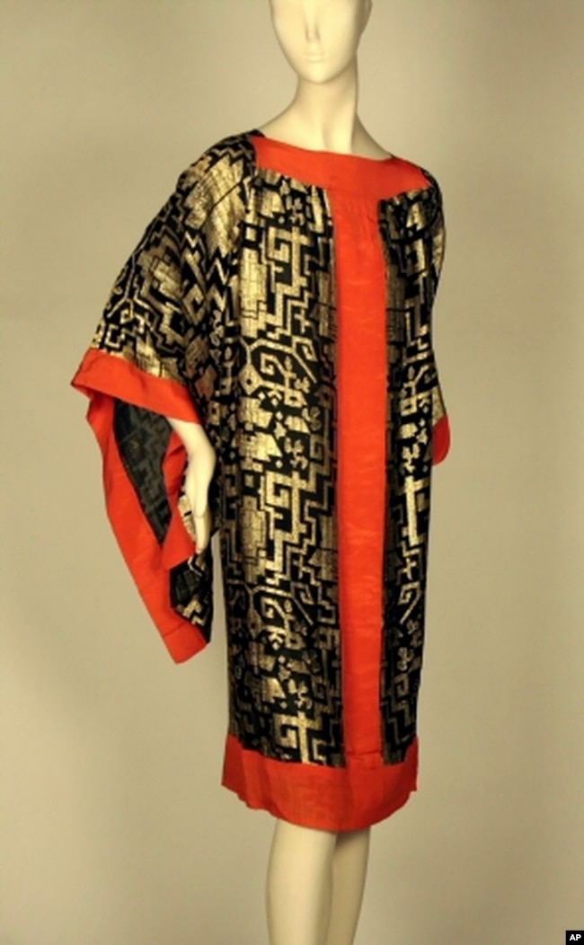 This image provided by the Museum of the City of New York shows a 1920s dress made of black silk chiffon with brocaded gold geometric motifs and red silk crepe. (Museum of the City of New York via AP)