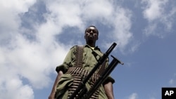 A Transitional Federal Government (TFG) soldier carrying a machine gun patrols the Indian Ocean coast-line in Burgabo, south of Kismayu in Somalia, (File).