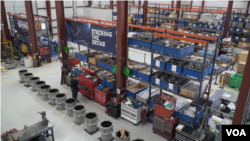 A worker is seen amid spare parts at a naval ship repair facility in Norfolk, Virginia. (Mary Cieslak/VOA)