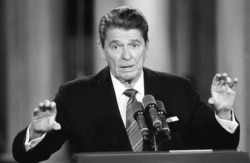 FILE - President Ronald Reagan gestures during a White House East Room news conference, May 22, 1984 in Washington.