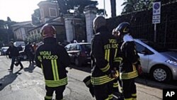 Italian firefighters stand in front of the Swiss Embassy in Rome where a parcel bomb exploded, 23 Dec 2010