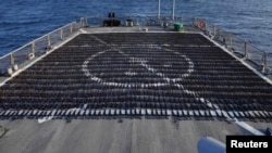 Thousands of AK-47 assault rifles, seized from a fishing vessel transiting along a maritime route from Iran to Yemen, sit on the flight deck of guided-missile destroyer USS The Sullivans (DDG 68) during an inventory process, in the Gulf of Oman in Arabian Sea, in this photo taken on Jan. 7, 2023 and released by U.S. Naval Forces on Jan. 10, 2023.