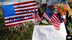 FILE - A memorial for U.S. Capitol Police officer Brian Sicknick is visible near the Capitol Building on Capitol Hill in Washington, Jan. 14, 2021. 