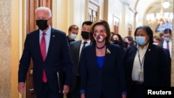 U.S. President Joe Biden arrives with Speaker of the House Nancy Pelosi, D-Calif., to meet with Democratic lawmakers at the U.S. Capitol to promote his bipartisan infrastructure bill on Capitol Hill in Washington, October 1, 2021. 