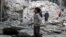 A boy inspects a damaged site after airstrikes on the rebel-held Tariq al-Bab neighbourhood of Aleppo, Syria, Sept. 23, 2016. 
