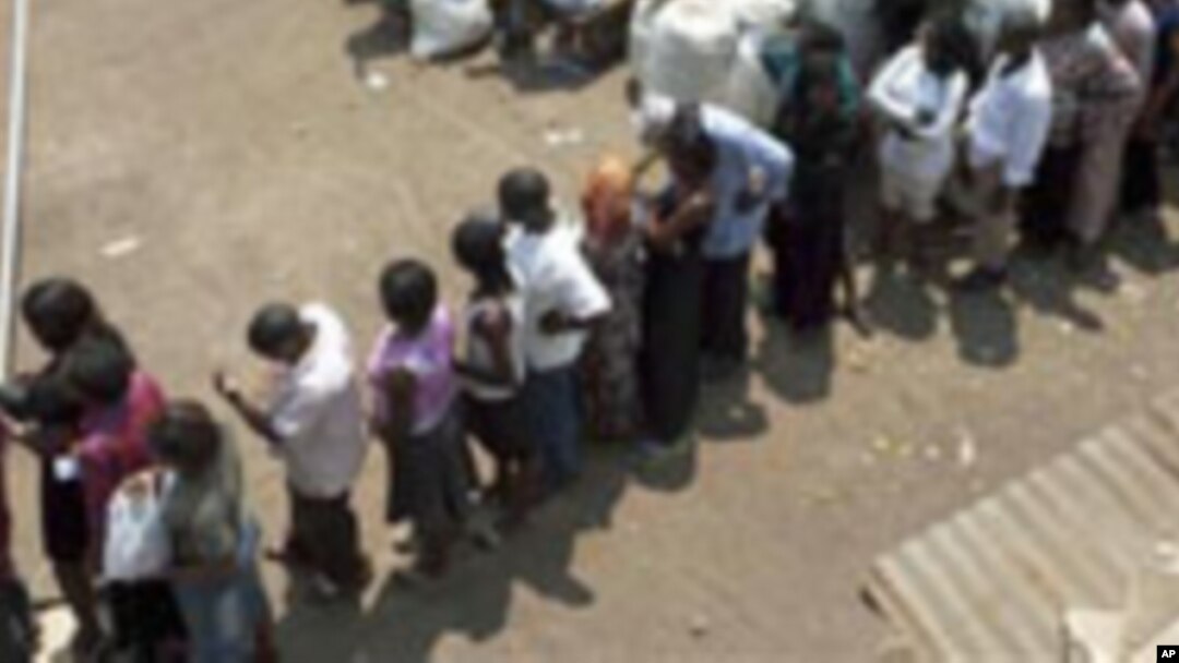 FILE – Voters line up at a polling station in Kampala, Uganda, in February 2011, as they wait to cast their ballot. 