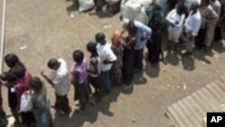 FILE – Voters line up at a polling station in Kampala, Uganda, in February 2011, as they wait to cast their ballot. 