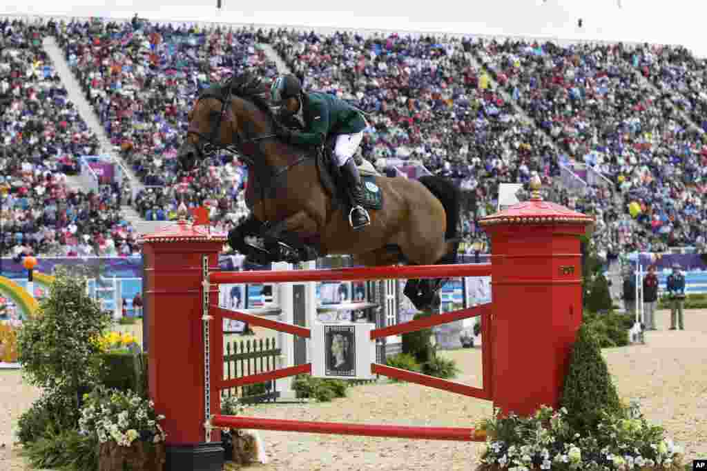 Kamal Bahamdan of Saudi Arabia rides his horse Nobless Des Tess in the equestrian show jumping team competition, in which Saudi received the bronze medal.