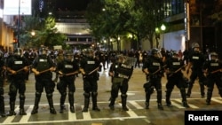 FILE - Police hold their lines in uptown Charlotte during a protest of the police shooting of Keith Scott in Charlotte, North Carolina, Sept. 21, 2016.