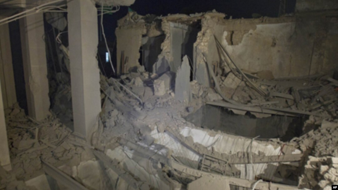 In this photo taken on a government organized tour, ruins of an official building are seen following an air strike in Tripoli, Libya, early Tuesday, May 10, 2011.